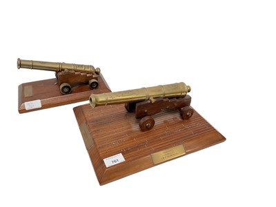 Lot 761 - Decorative brass model of a Naval Cannon, mounted on wooden base, together with another similar model cannon (2).