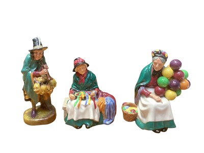 Lot 1205 - Three Royal Doulton figures - The Mask Seller HN2103, Silks and Ribbons HN2017 and The Old Balloon Seller HN1315