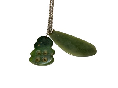 Lot 106 - Māori green hardstone tiki pendant and another green hardstone pendant on a silver chain, together with other similar pendants
