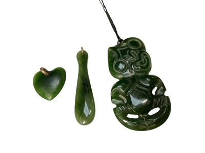 Lot 106 - Māori green hardstone tiki pendant and another green hardstone pendant on a silver chain, together with other similar pendants
