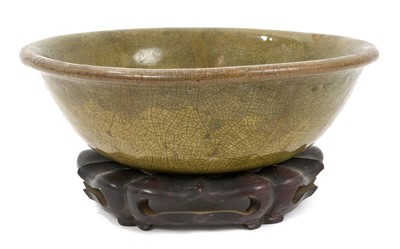 Lot 263 - Early Chinese celadon glazed bowl, with hardwood stand