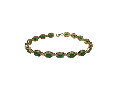 Lot 109 - Gold emerald and synthetic white stone cluster bracelet
