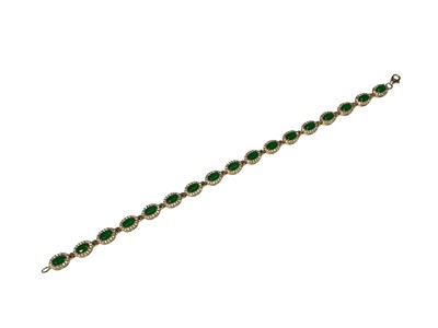 Lot 109 - Gold emerald and synthetic white stone cluster bracelet