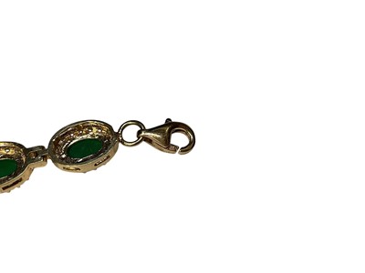 Lot 109 - Gold emerald and synthetic white stone cluster bracelet