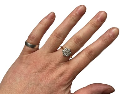 Lot 111 - 18ct gold diamond flower head cluster ring