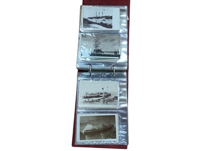 Lot 1413 - Postcards in two albums including real photographic street scenes, photographic, black and white and coloured shipping some identified, 1912 Launching of H M S Ironduke, Portsmouth , H M S Canop...