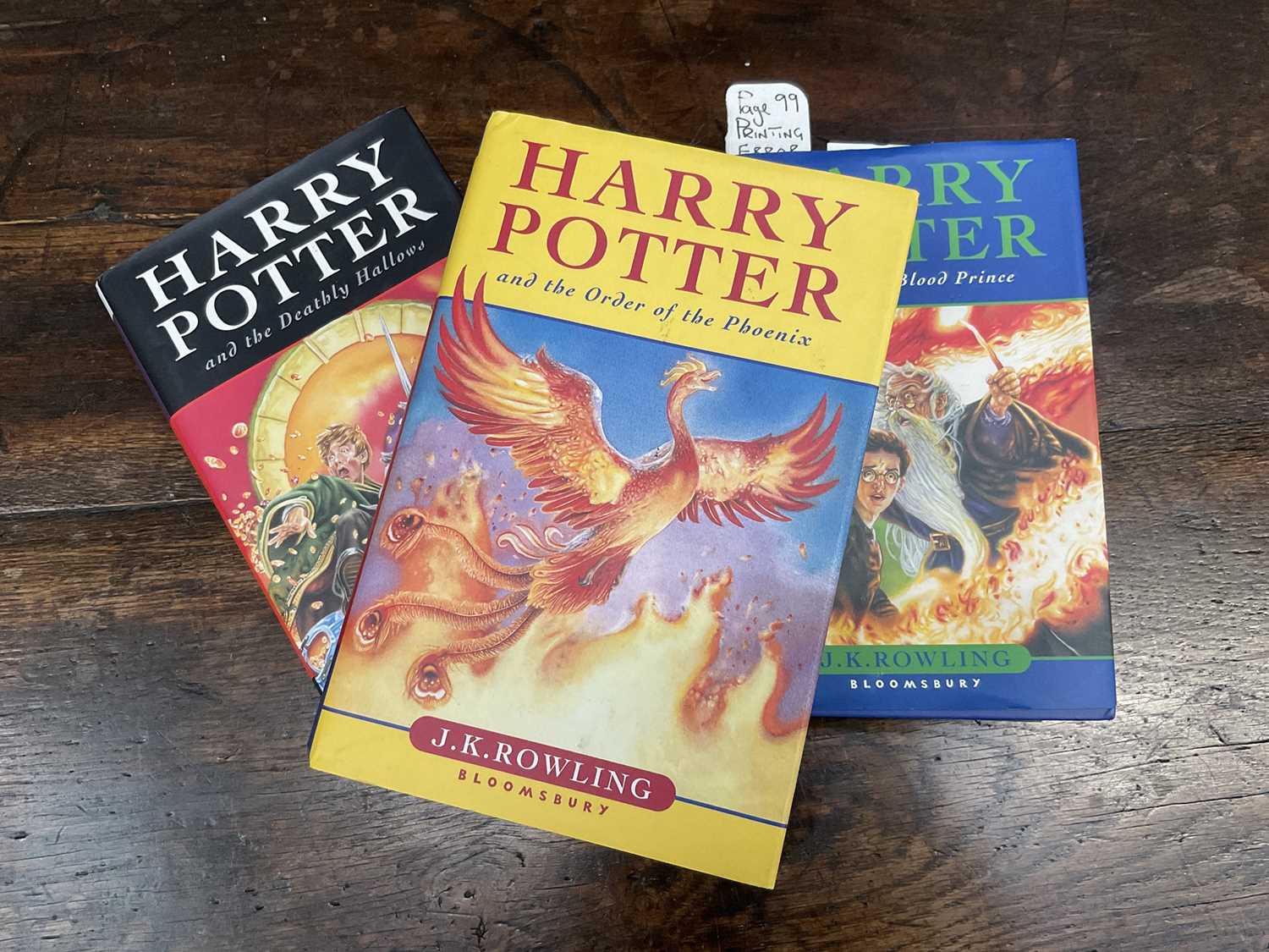 Lot 1689 - Three First Edition Harry Potter books to include the Half-Blood Prince with rare page 99 printing error with the misprint 'eleven owls'. Order of The Phoenix and Deathly Hallows. (3)