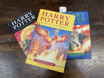 Lot 1689 - Three First Edition Harry Potter books to include the Half-Blood Prince with rare page 99 printing error with the misprint 'eleven owls'. Order of The Phoenix and Deathly Hallows. (3)