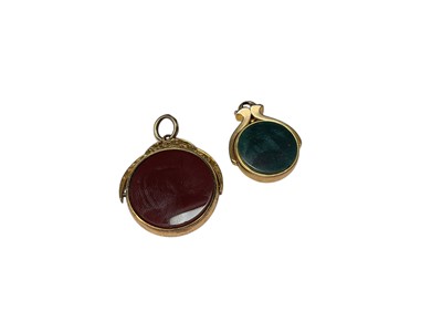 Lot 179 - Two rotating hardstone fobs in 9ct gold mounts
