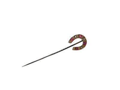 Lot 188 - Horseshoe stick pin set with rose cut diamonds and pink stones