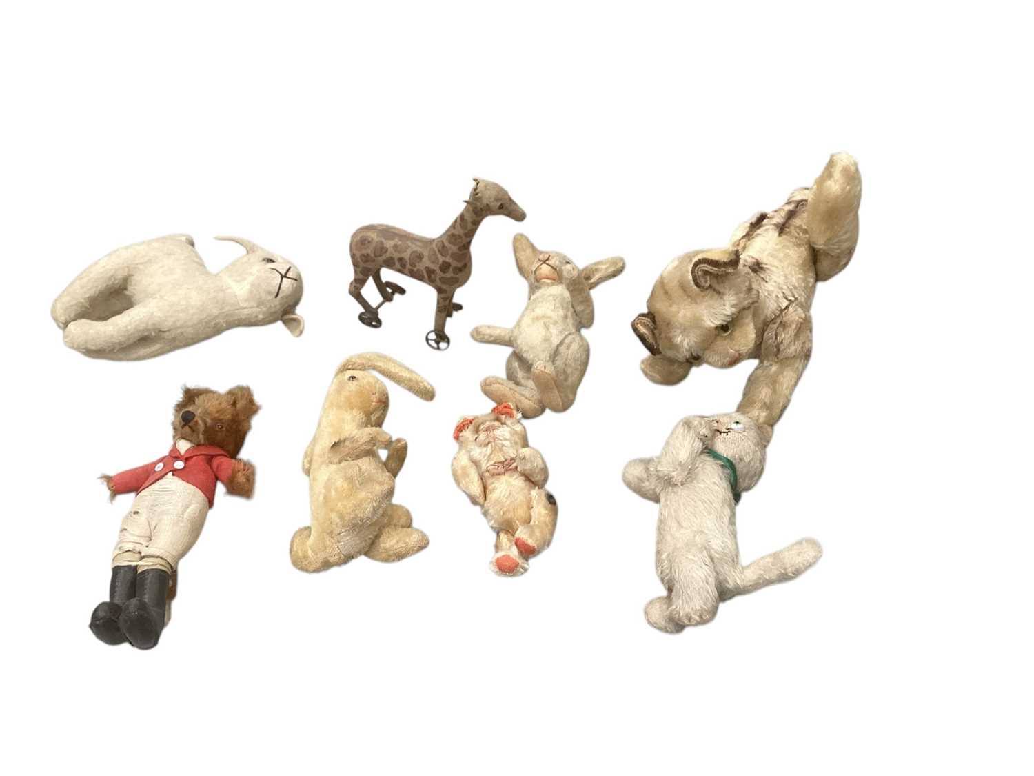 Lot 1971 - Group of mohair soft toys including Huntsman Fox, rabbits, kittens etc, some jointed some swivel heads, some possibly Steiff. Plush small suede push-a-long giraffe, metal wheels.