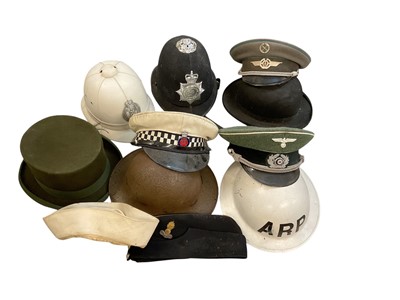 Lot 741 - Group of various military related helmets including Second World War Zuckerman Civil Defence helmet, replica Second World War British A.R.P. helmet and various Police hats (1 box).
