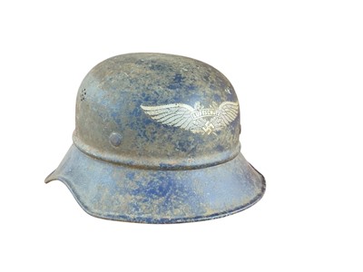 Lot 743 - Second World War Nazi Luftschutz helmet with original paint, transfer badge and lining.