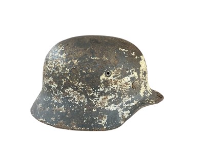 Lot 744 - Second World War Nazi M40 pattern helmet in relic condition with traces of single decal and camouflage painted finish and leather lining to interior.