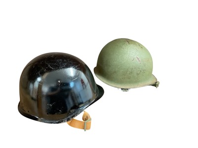 Lot 747 - American M1 steel helmet with lining, together with a Post Second World War German helmet (2).