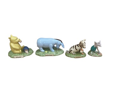 Lot 1225 - Four large Royal Doulton limited edition figures - Pooh Began To Eat WP28, Tigger Loves Tigger Lillies WP27, Piglet Planting A Haycorn WP26 and Eeyore's Nose To The Ground WP25, all boxed with c...