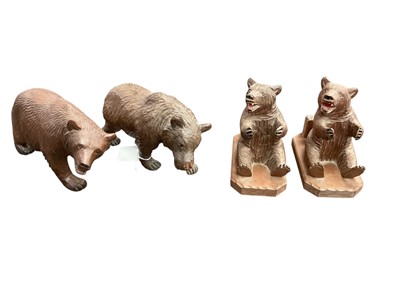 Lot 2490 - Four early to mid-20th century German Black Forest carved wooden bear ornaments pair bear pipe rests/ match box holders (4)