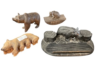 Lot 2491 - Four early to mid-20th century German Black Forest carved wooden novelty bear ornaments including desk stand, blotter and brush (4)