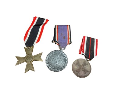 Lot 776 - Nazi German War Merit Medal together with a Nazi German War Merit Cross and a Luftschutz decoration (3).