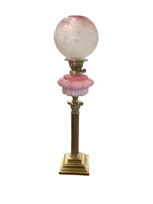 Lot 2504 - Late Victorian brass Corinthian column oil lamp with moulded and pink tinted glass reservoir and pink tinted and etched glass shade approx 84cm