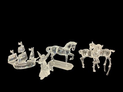 Lot 1278 - Four Swarovski Crystal ornaments -Hummingbird, Galleon and Horses, all boxed