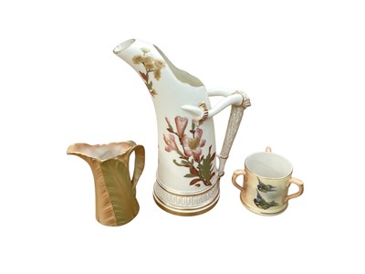 Lot 1283 - Royal Worcester blush ivory ewer with floral decoration, no. 1116, together with a three handled mug decorated with birds and a jug (3)