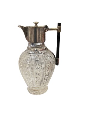 Lot 564 - Late Victorian cut glass claret jug with Christopher Dresser style mounts