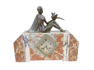 Lot 2597 - 1930's French Art Deco marble mantel clock with silvered Arabic numeral dial, the rouge marble case mounted with bronzed metal figure of a seated female, 40cm in length