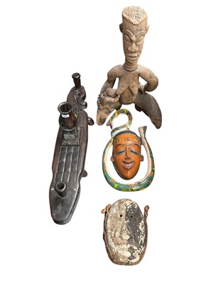 Lot 2560 - Collection of tribal carvings, including figures and masks some painted