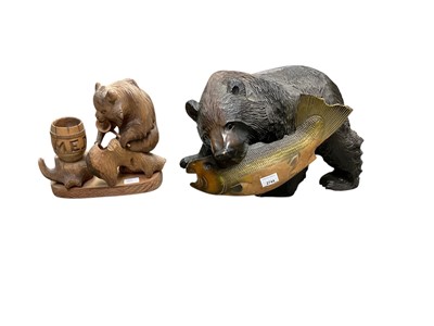 Lot 2744 - Large modern carved wood Black Forest bear ornament depicting a bear with a fish in its mouth, together with another novelty Black Forest bear ornament (2).