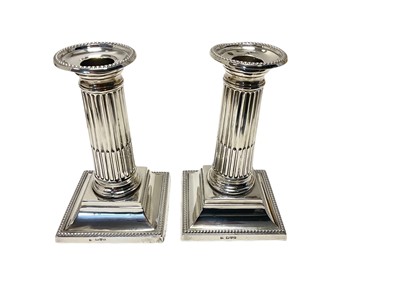 Lot 229 - Pair of Edwardian silver Corinthian column candlesticks, Chester 1904