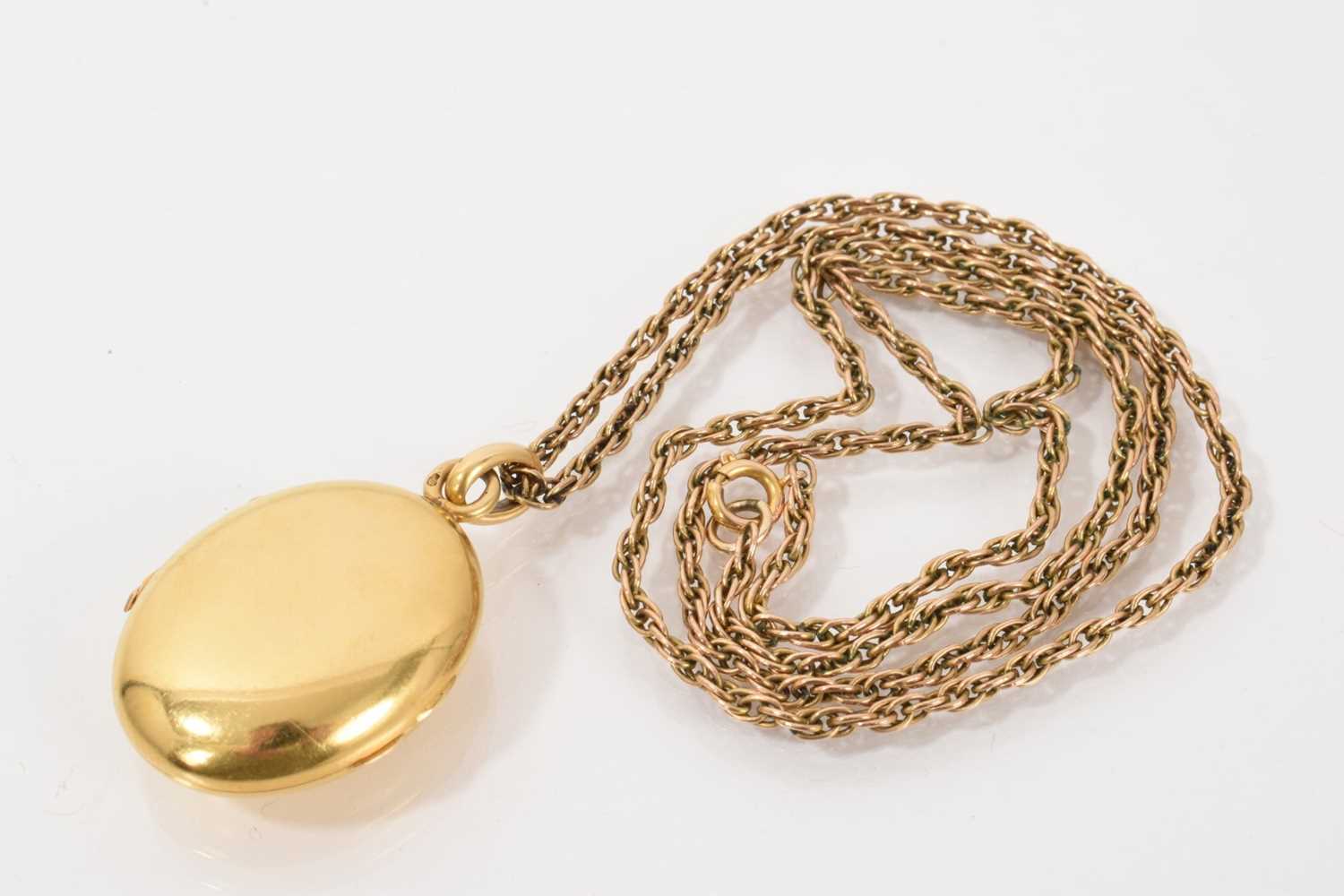 Lot 537 - 19th century French gold oval locket on a yellow metal rope twist chain