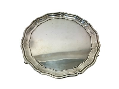 Lot 332 - George III style silver salver with piecrust edging on scroll feet (Chester 1935)