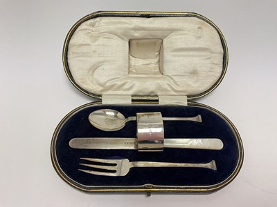 Lot 78 - Art Deco silver christening set comprising of knife with mother of pearl handle, fork, spoon (all Sheffield 1922) and a napkin ring, in fitted case