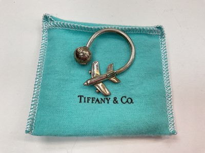 Lot 1010 - Tiffany & Co silver aeroplane and globe key ring (London 1999), in pouch