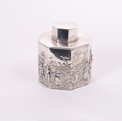 Lot 179 - George V silver tea caddy of octagonal form with embossed Dutch style figural decoration landscape, with slip on cover, (Chester 1912), makers mark rubbed approximately 6oz, 8.5cm in height