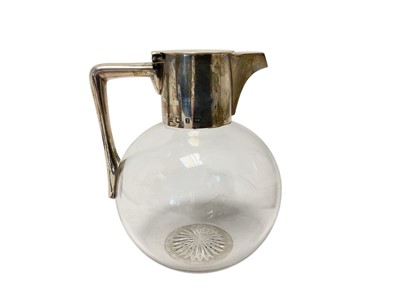 Lot 184 - Victorian silver mounted glass claret jug of globular form with star cut base, (Birmingham 1898), maker Hukin & Heath, 16cm in overall height. NB. In the style of Dr Christopher Dresser