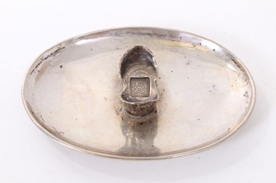 Lot 192 - Chinese silver dish of dished oval form on an oval base and mounted with a Chinese boat shaped silver Sycee ingot, underside with label referring to late 1920s. All at approximately 3ozs. 11cm a...