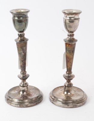 Lot 188 - Pair of contemporary silver candlesticks, with tapering columns and urn candleholders, on circular bases, filled (Birmingham 1976 / 77) Mappin & Webb. 21cm overall height.