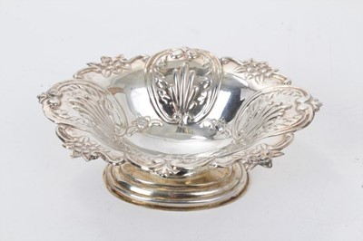 Lot 189 - Contemporary silver bonbon dish of oval form, with panels of raised decoration, on an oval base (London 1967), maker D&D, all at approximately 3ozs, 15cm across