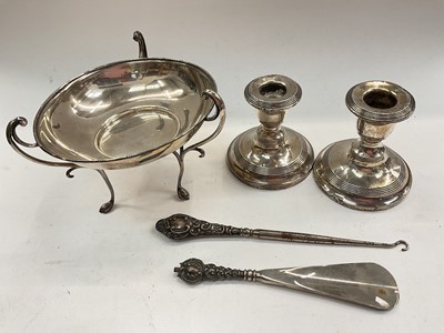 Lot 1109 - Silver dish raised on three feet, pair of silver squat candlesticks and two silver handled items