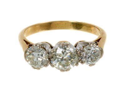 Lot 497 - Diamond three stone ring with three brilliant cut diamonds in platinum claw setting on gold shank