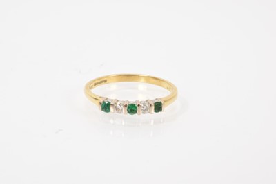 Lot 587 - 18ct gold emerald and diamond five stone ring