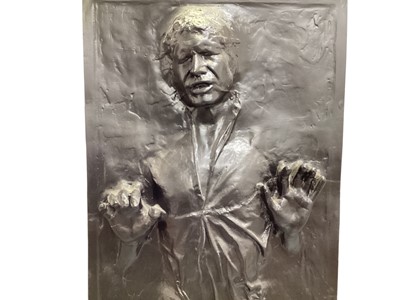 Lot 298 - Hans Solo in carbonite moulded plastic impression 645cm x 915cm, plus GB Eye DP0473 poster of Hans Solo in carbonite printed in UK (2)