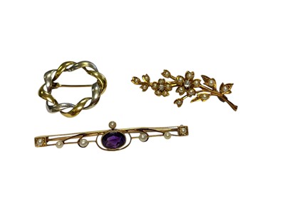 Lot 116 - Edwardian gold diamond and seed pearl floral spray brooch, Edwardian 15ct gold amethyst and seed pearl brooch and a yellow and white gold twisted wreathe brooch (3)