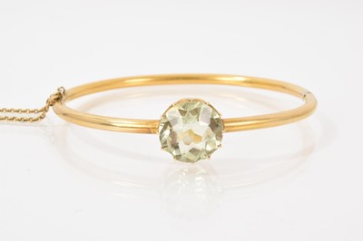 Lot 517 - Victorian gold hinged bangle with a pale green stone in claw setting