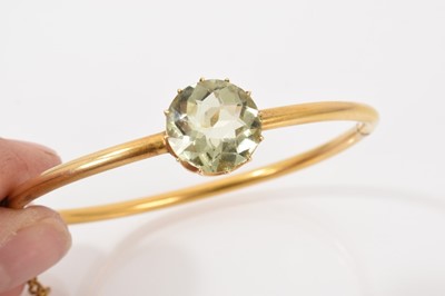 Lot 517 - Victorian gold hinged bangle with a pale green stone in claw setting