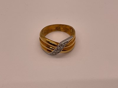 Lot 26 - 18ct gold and diamond ring with triple band in a crossover design