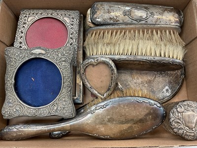 Lot 1102 - Silver backed dressing table hand mirror and brushes, various silver photograph frames, silver topped glass jar, two plated serving spoons and a plated ladle