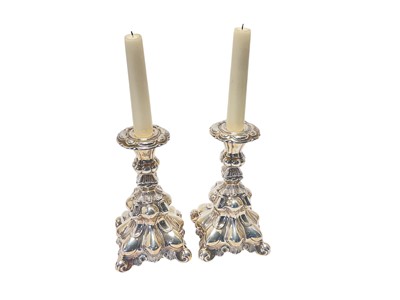 Lot 231 - Pair of 20th century Danish silver candlesticks, with ornate decoration and urn shaped candle holders, integral sconces and weighted bases (Danish assay marks). 18cm overall height, excluding candles.